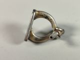 a silver ring with a hole in it on a white surface