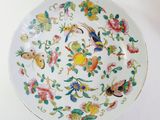 a white plate with colorful flowers and birds on it