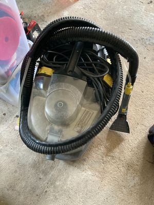 a vacuum that is sitting on the floor next to a bag
