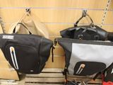 two bags hanging on the wall next to a stroller