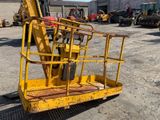 a yellow crane that is sitting in a parking lot