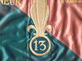a close up of a flag with a gold and blue design on it