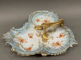 a blue and gold plate with a handle on it