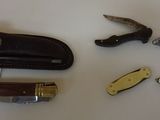 a knife, a pocket knife, a pocket knife, and a pocket knife on a table
