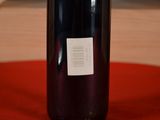 a bottle of wine sitting on a table with a label on it