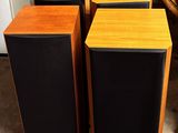 two speakers sitting next to each other on the floor