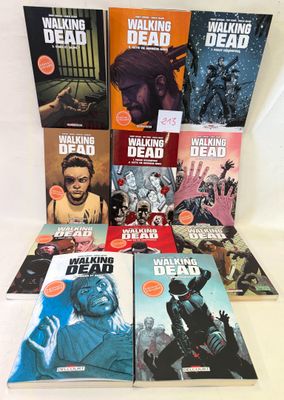 the walking dead comic books are stacked on a table