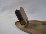 a small metal object with a cell phone on it