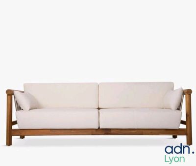 an image of a white couch with a wooden frame on a white background