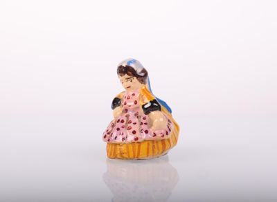 a figurine of a woman in a pink dress