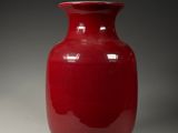 a red vase that is sitting on a table