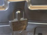 a silver oven with a metal door and a wire plugged into it
