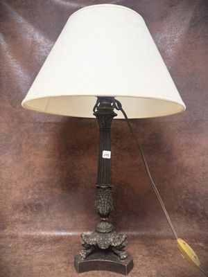 a lamp that is sitting on a table with a white shade