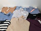 a lot of sweaters that are on a white table