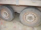 two tires that are sitting on the side of a truck
