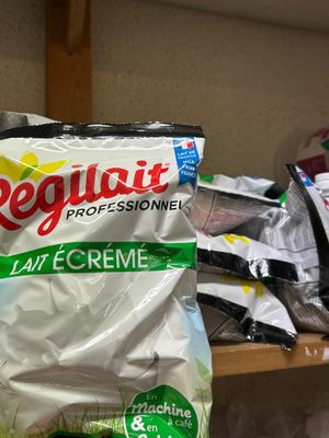 a bag of cream sitting on a shelf next to a pile of other items