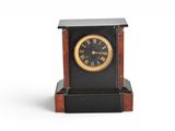 a black and gold clock sitting on top of a wooden stand