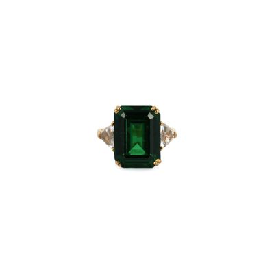 a close up of a ring with a green stone on it