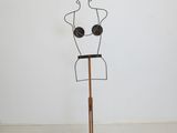 an image of a sculpture of a woman ' s torso on a wooden stand