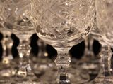 several empty wine glasses are lined up on a table