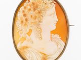 an antique cameo of a woman with flowers in her hair