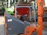 a large orange machine that is sitting in the dirt