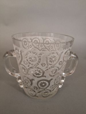 a glass cup with a handle on a table