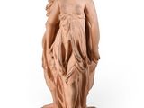 statue of a woman holding a bird on a pedestal