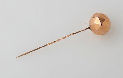 an image of a rose gold hair pin on a white surface