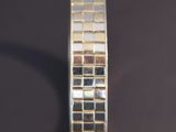 a close up of a gold bracelet on a black surface