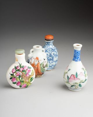 three small vases with designs on them sitting next to each other
