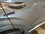 a close up of a car door handle with a sticker on it