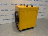 a yellow air conditioner sitting on top of a floor next to a wall