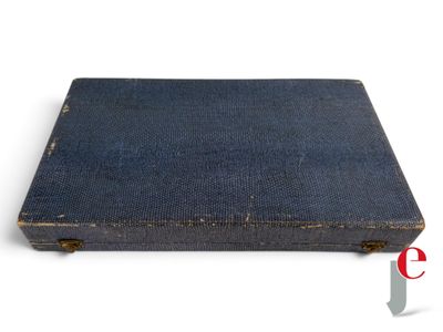 an old blue book sitting on top of a white surface