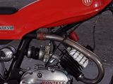 a red motorcycle that is parked in a parking lot