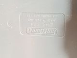 a close up of a white vase with a label on it
