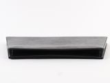 a black wallet sitting on top of a white surface