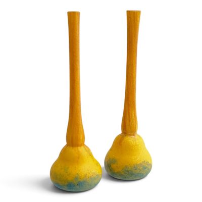 pair of yellow and blue vases sitting on a white surface