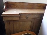 a wooden cabinet with a mirror on top of it