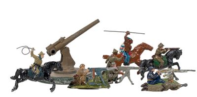 a group of figurines of people riding horses and a cannon