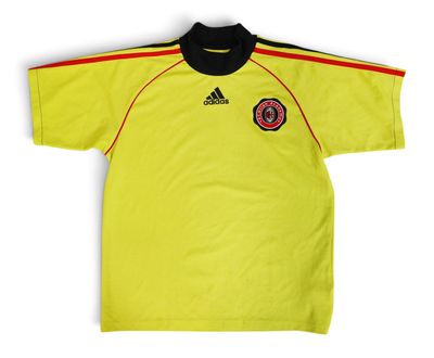 a yellow shirt with a black collar and a red stripe on the chest