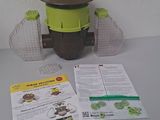 a green and brown object on a table next to a pamphlet