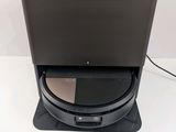 a close up of a black speaker on a stand with a white background