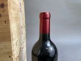 a bottle of wine sitting next to a wooden box