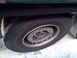 a green truck that has a flat tire on it
