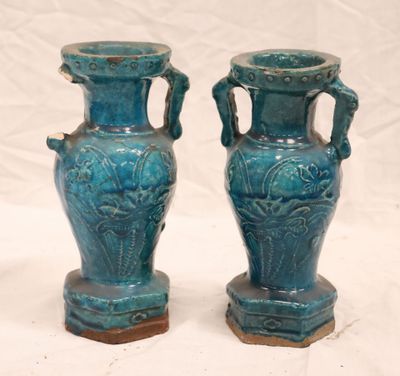 two blue vases that are sitting on a table
