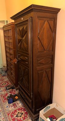 a large wooden cabinet in the corner of a room