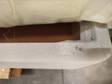 a bed with a white cover and a pillow on it
