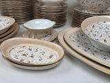 many plates and bowls that are sitting on a table