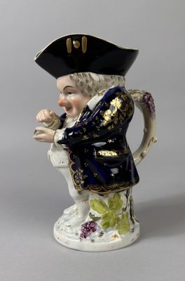 a figurine of a man wearing a hat and holding a pipe